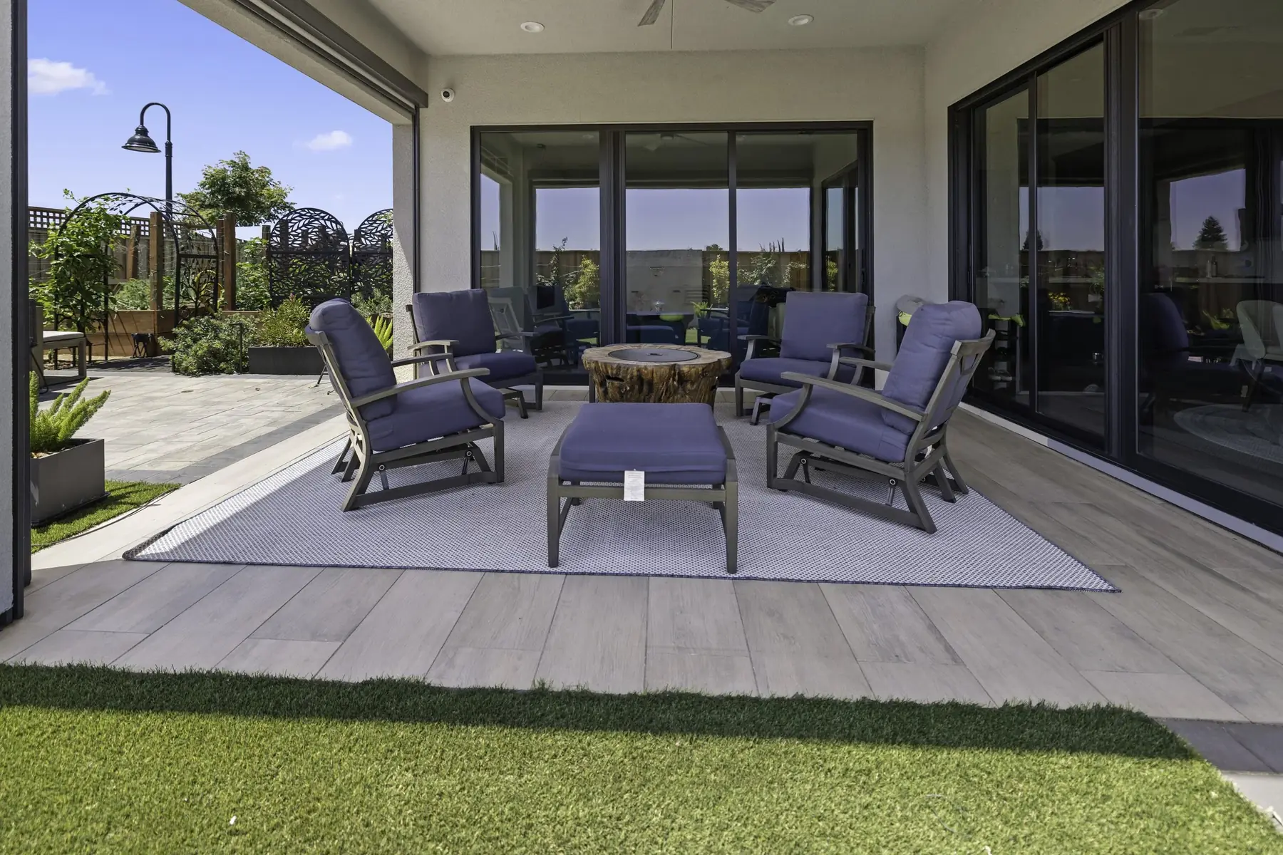 Covered patio lounge with layered lighting at dusk